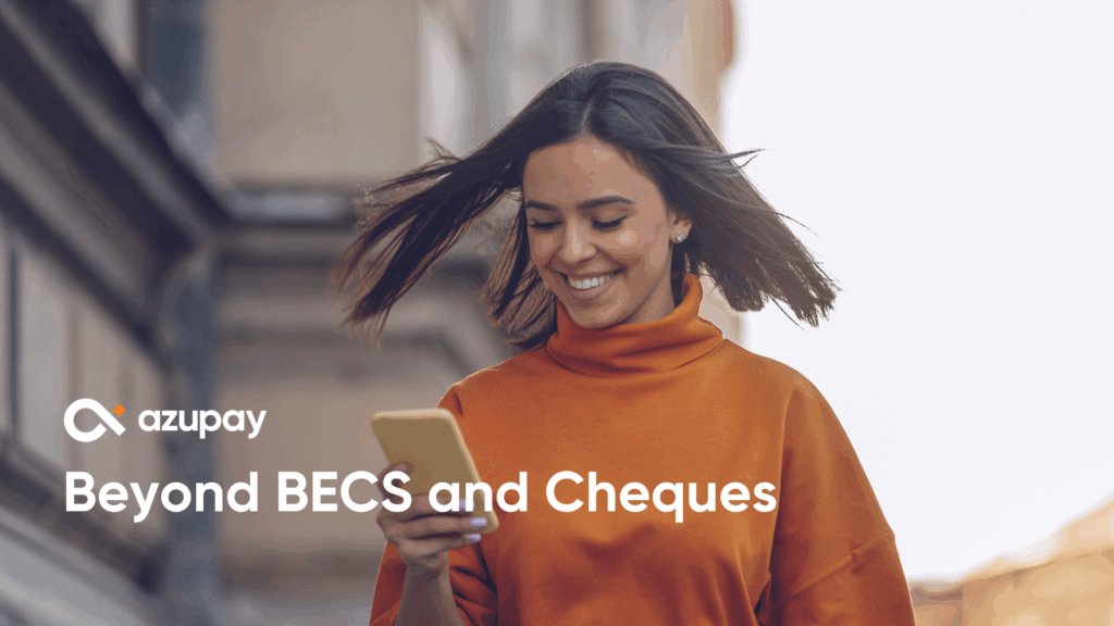A person walking outdoors and smiling while looking at their phone. They’re wearing an orange turtleneck, and their hair is moving in the breeze. The Azupay logo and the text “Beyond BECS and Cheques” appear on the left side of the image.